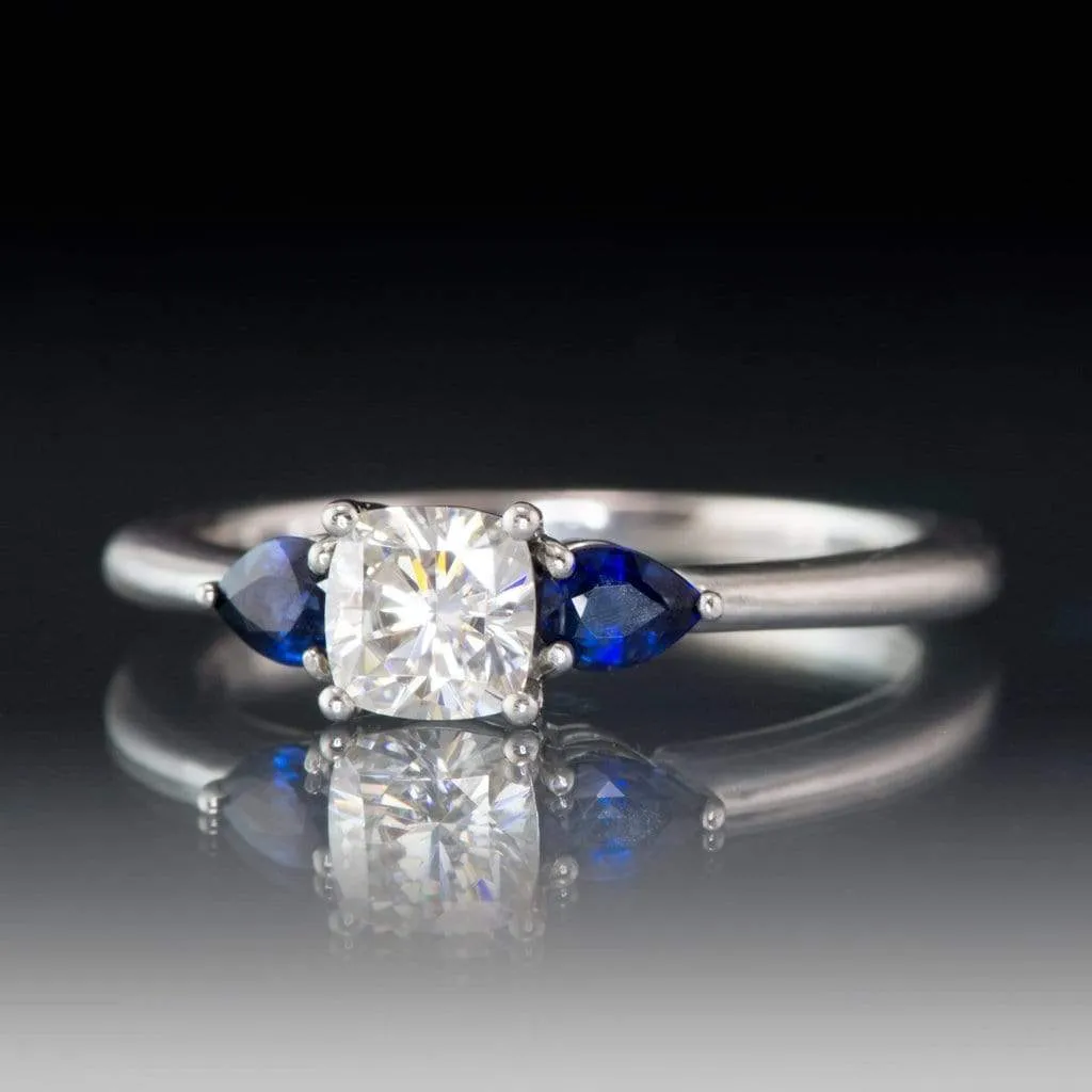 Tressa- Three Stone Engagement Ring, Prong set Cushion Moissanite & Pear Blue Sapphire Accents