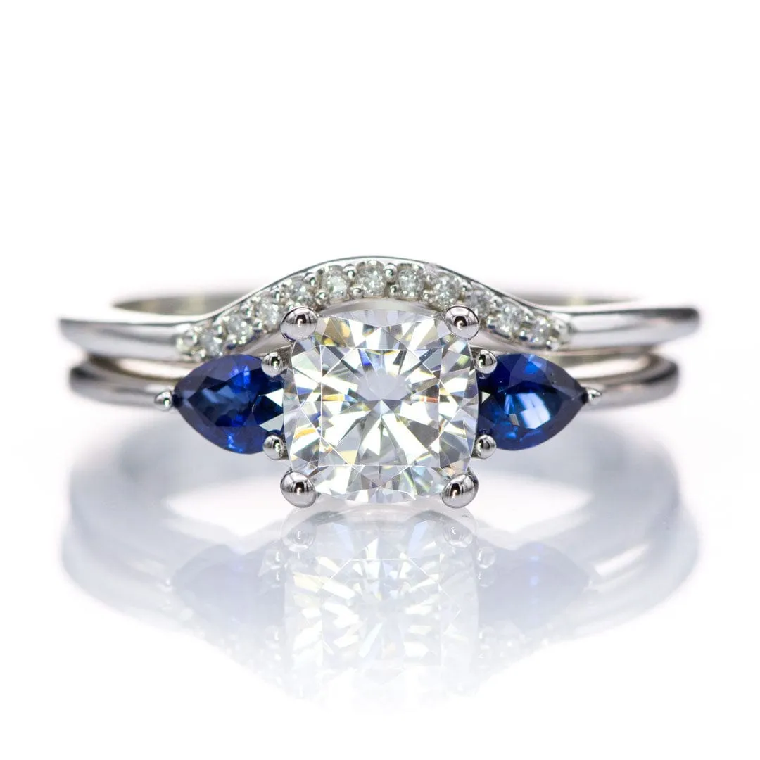 Tressa- Three Stone Engagement Ring, Prong set Cushion Moissanite & Pear Blue Sapphire Accents