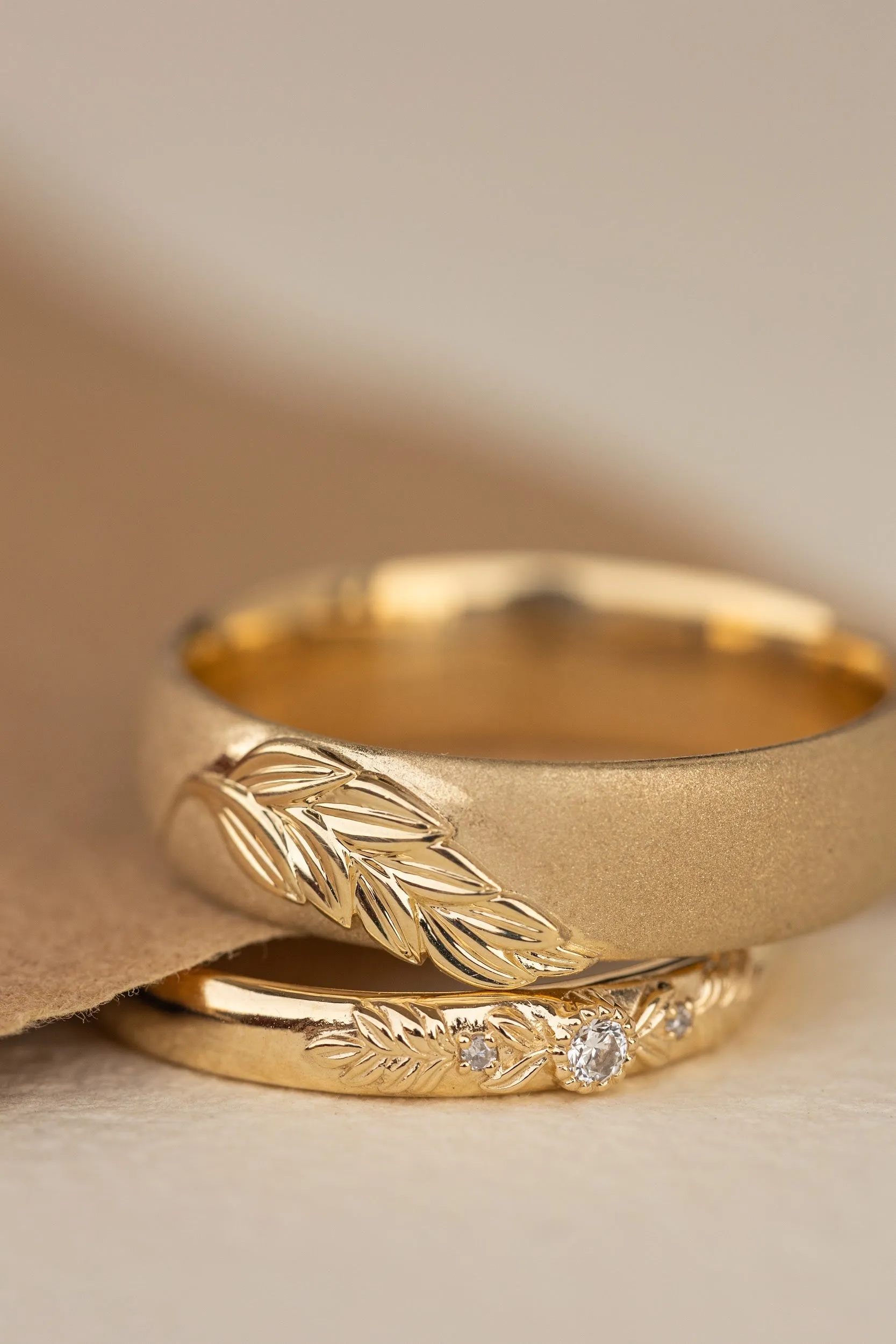 Wedding rings set for couples: satin band with palm leaf for him, wreath ring with gemstones for her