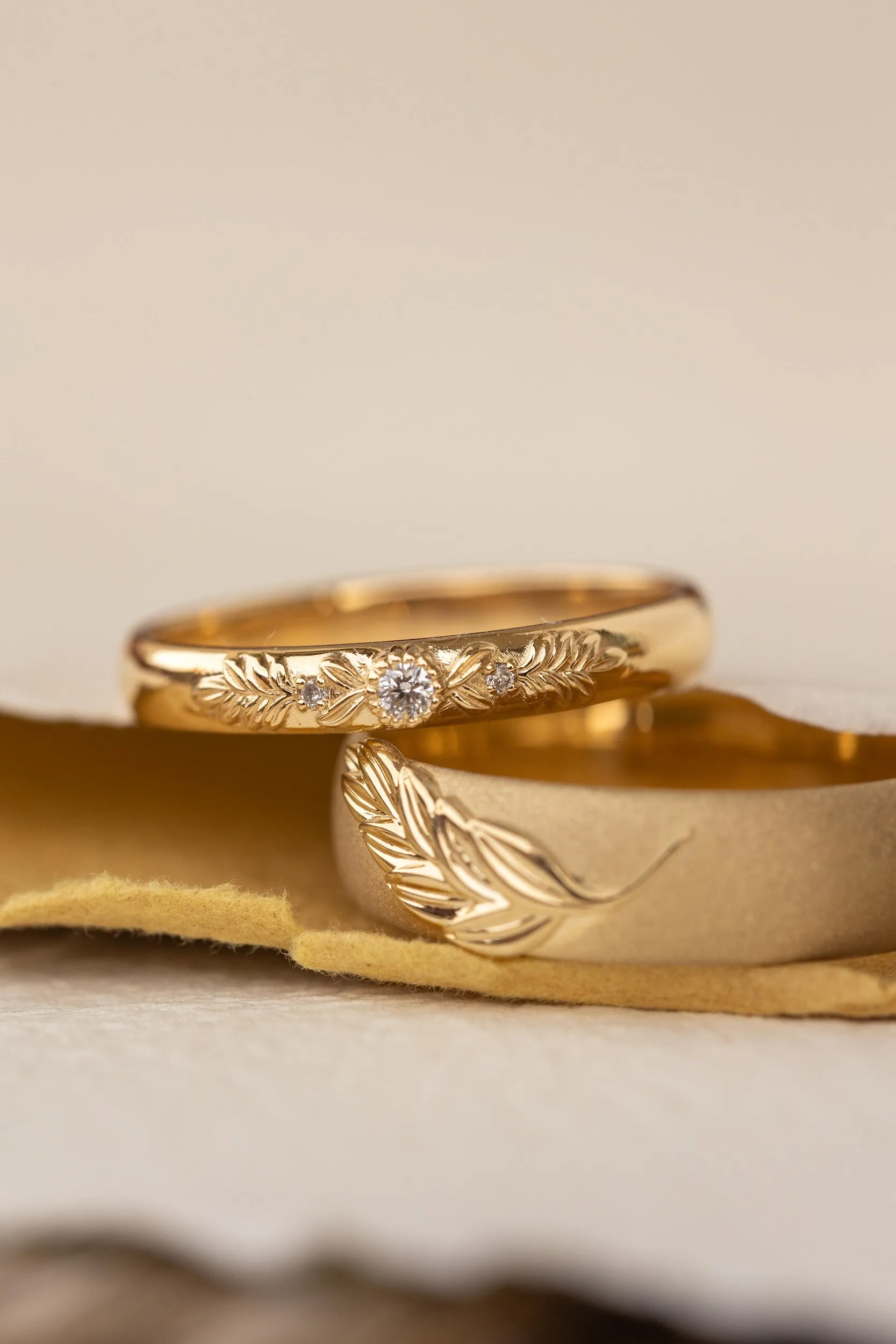 Wedding rings set for couples: satin band with palm leaf for him, wreath ring with gemstones for her